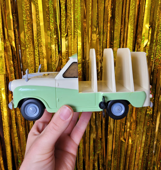 Side of the model van with 4 slots to put slices of toast in. Against a gold sparkly tinsel background