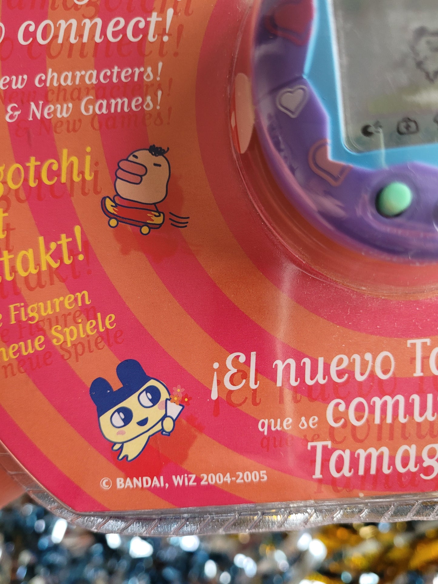 Close up of tamagotchi packaging saying 2004-2005 with a picture of a tamagotchi character on a skateboard