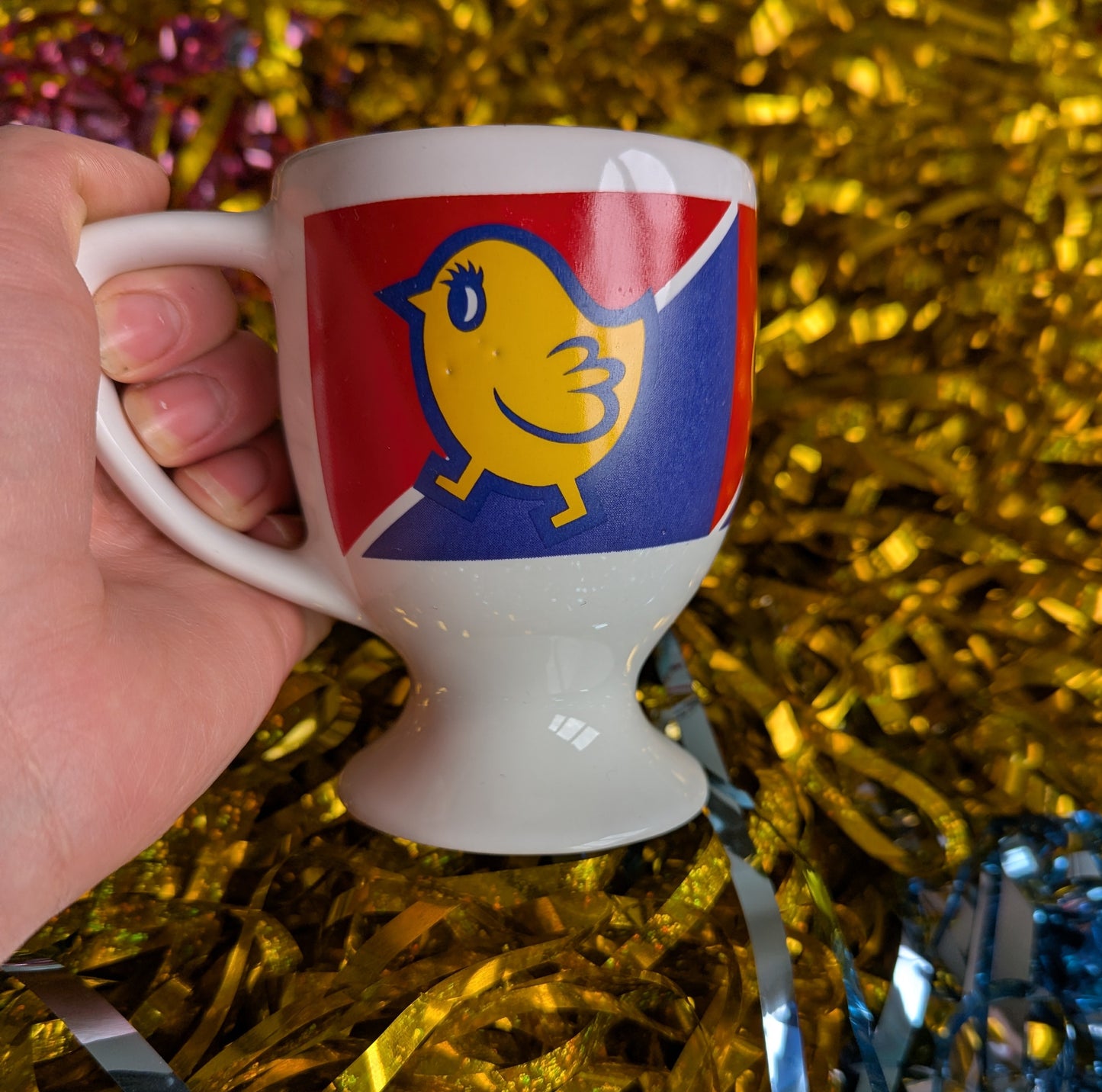 Side of the mug with chick logo with 2 small indents