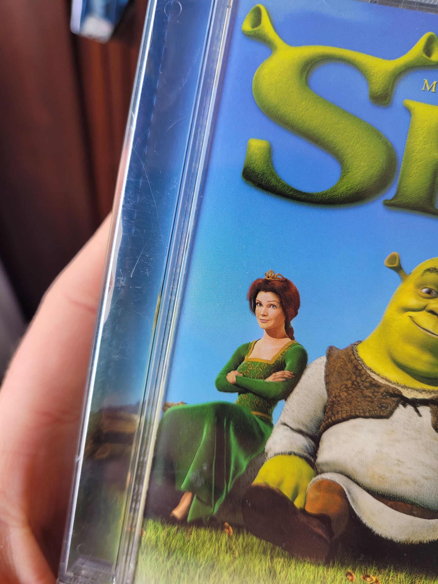 Close up of the left side of the CD case with some light scratch marks 