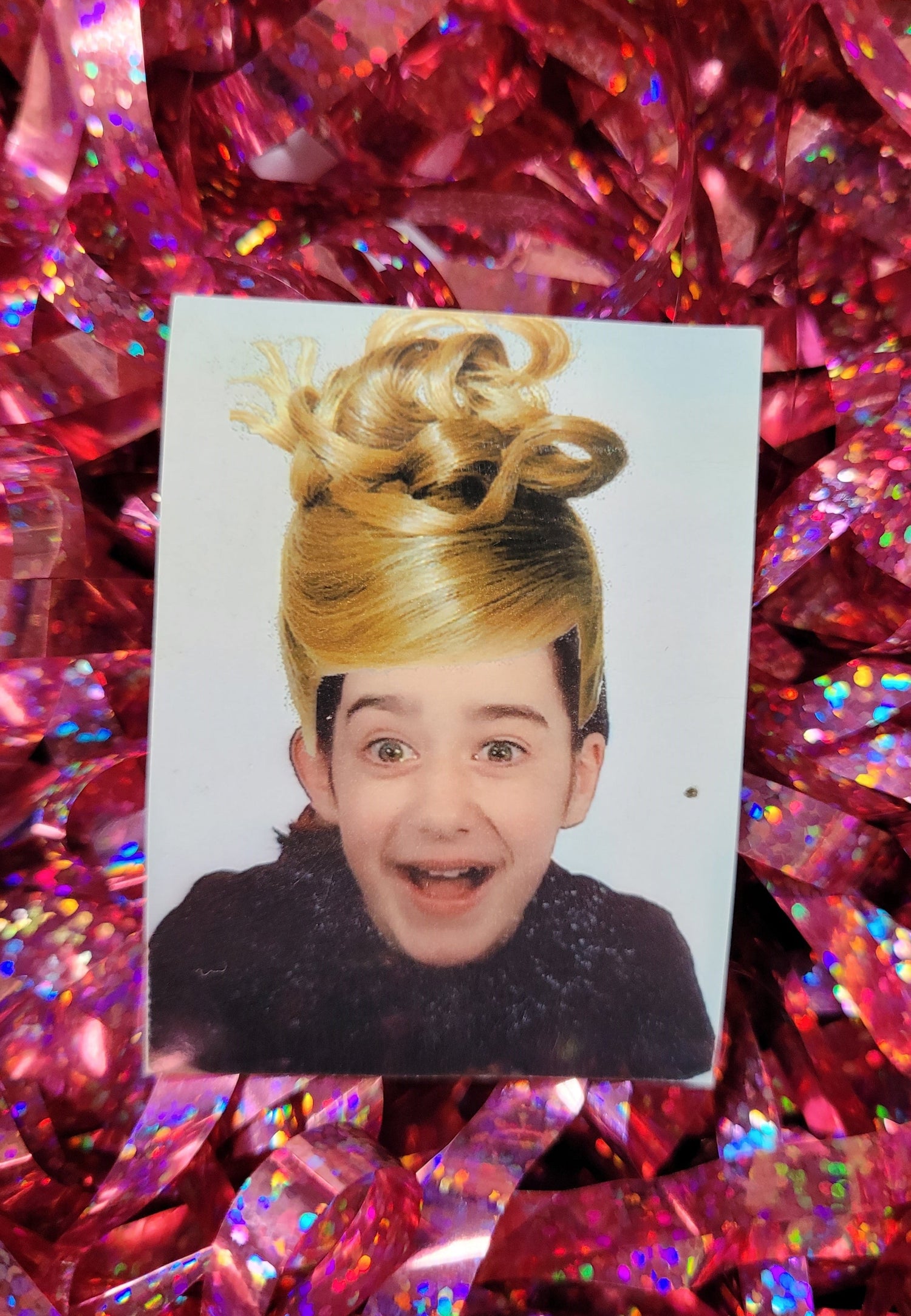 photo booth picture in colour of me as a child smiling with my mouth open with a blonde wig photoshopped on top of my head badly