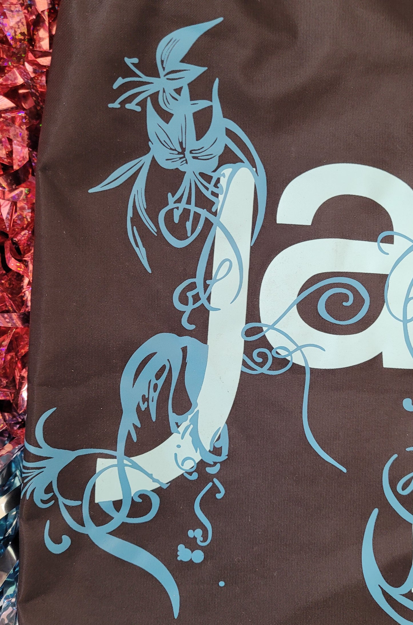 Close u[p of the floral decoration surrounding the letter 'J'