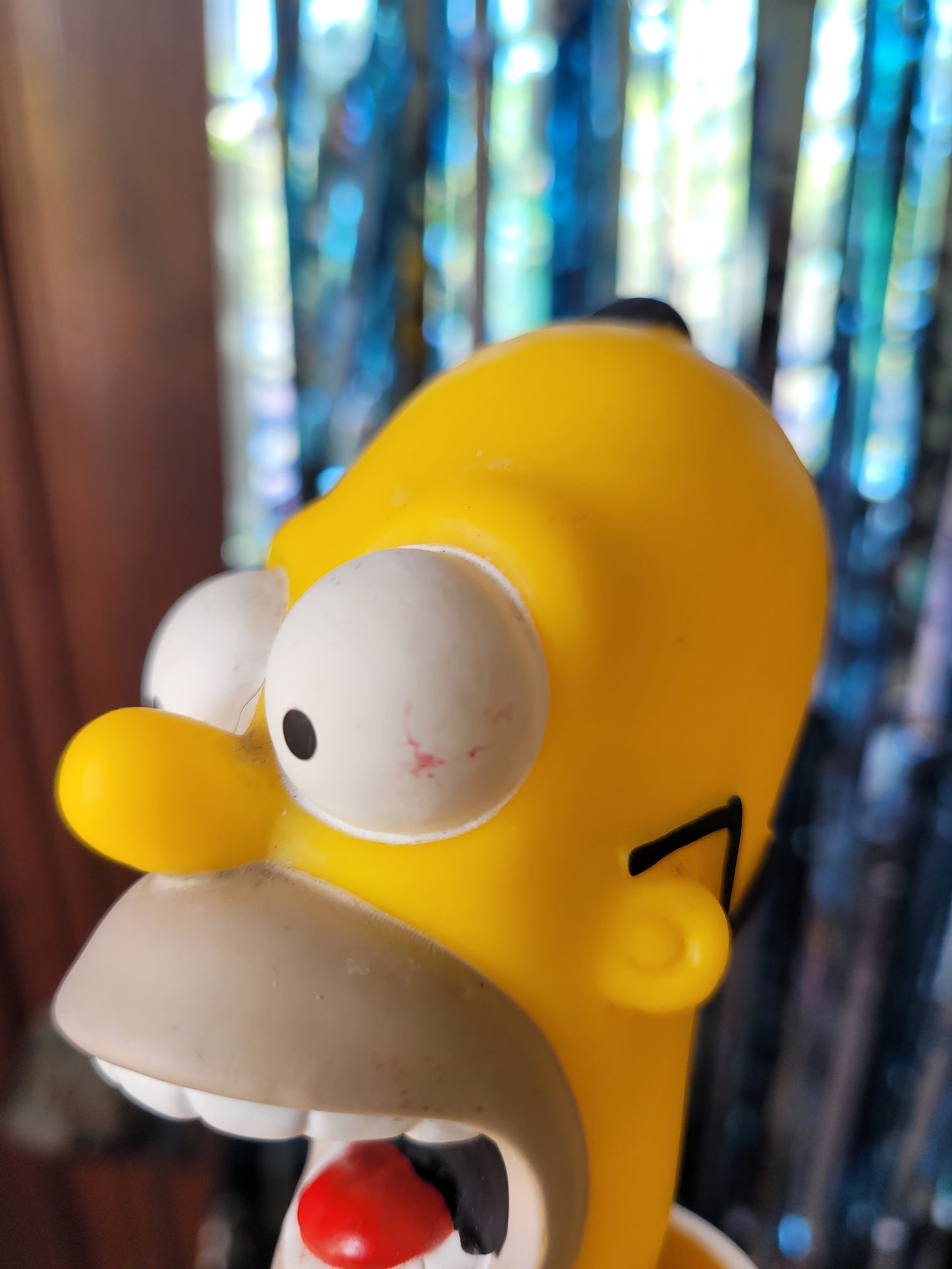 Closeup of Homer's head with small scuff mark on the eye