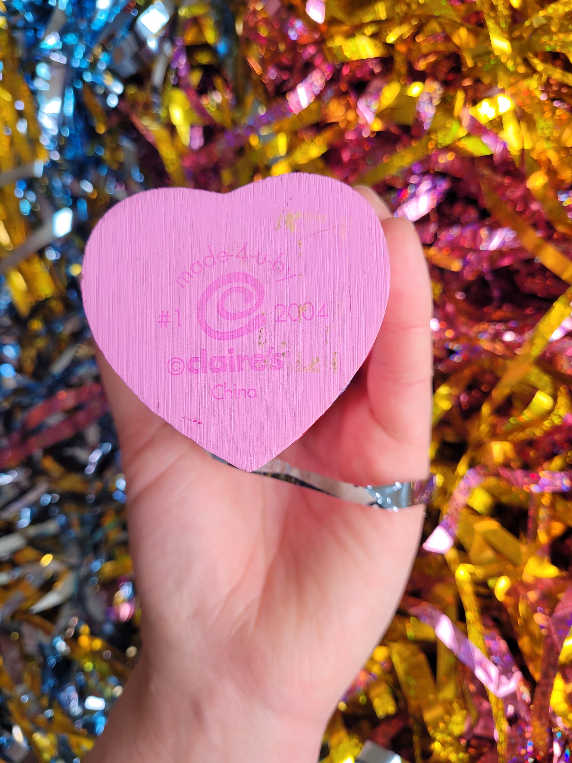 Bottom of the trinket box which reads made 4 u Claire's 2004 with the squiggly spiral Claire's logo