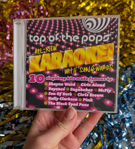 Pink and black CD case reading 'top of the Pops. all new karaoke with song words'