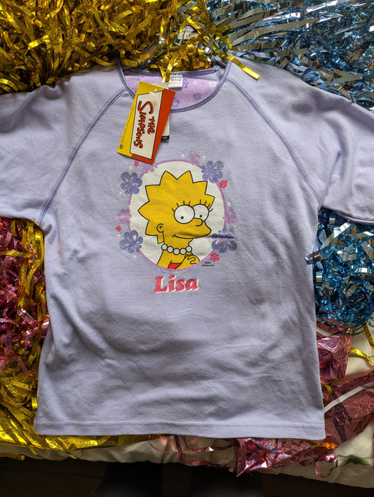 lilac Lisa simpson pyjama top on a Matalan coat hanger with colourful tinsel background
