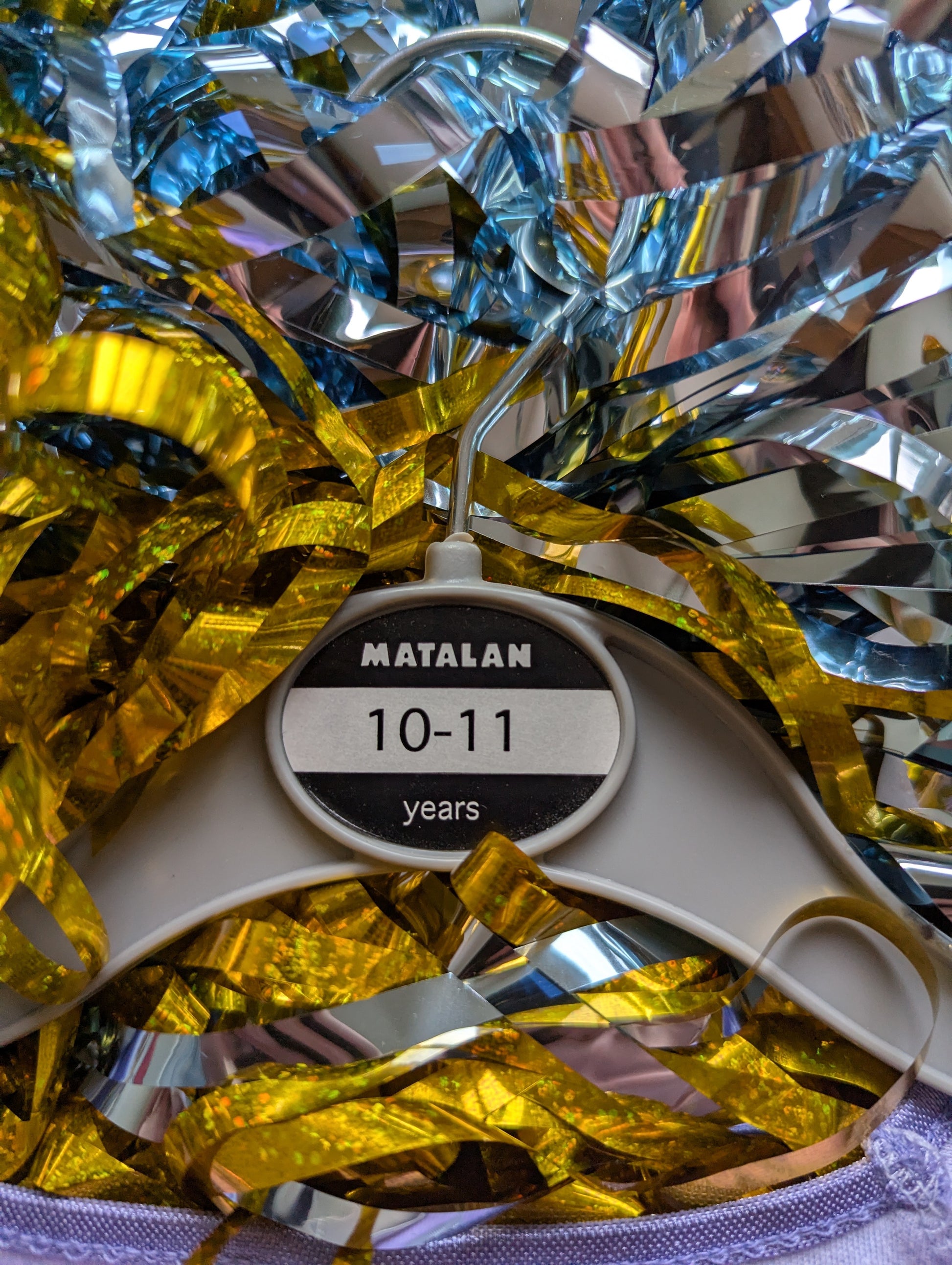 Matalan clothes hanger reading 10-11 years