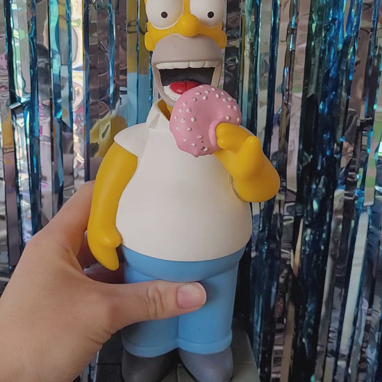Homer bobblehead nodding back and forth looking like he's taking bites out the donut