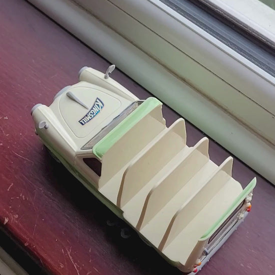 van rolls across a windowsill with a bit of a nudge 